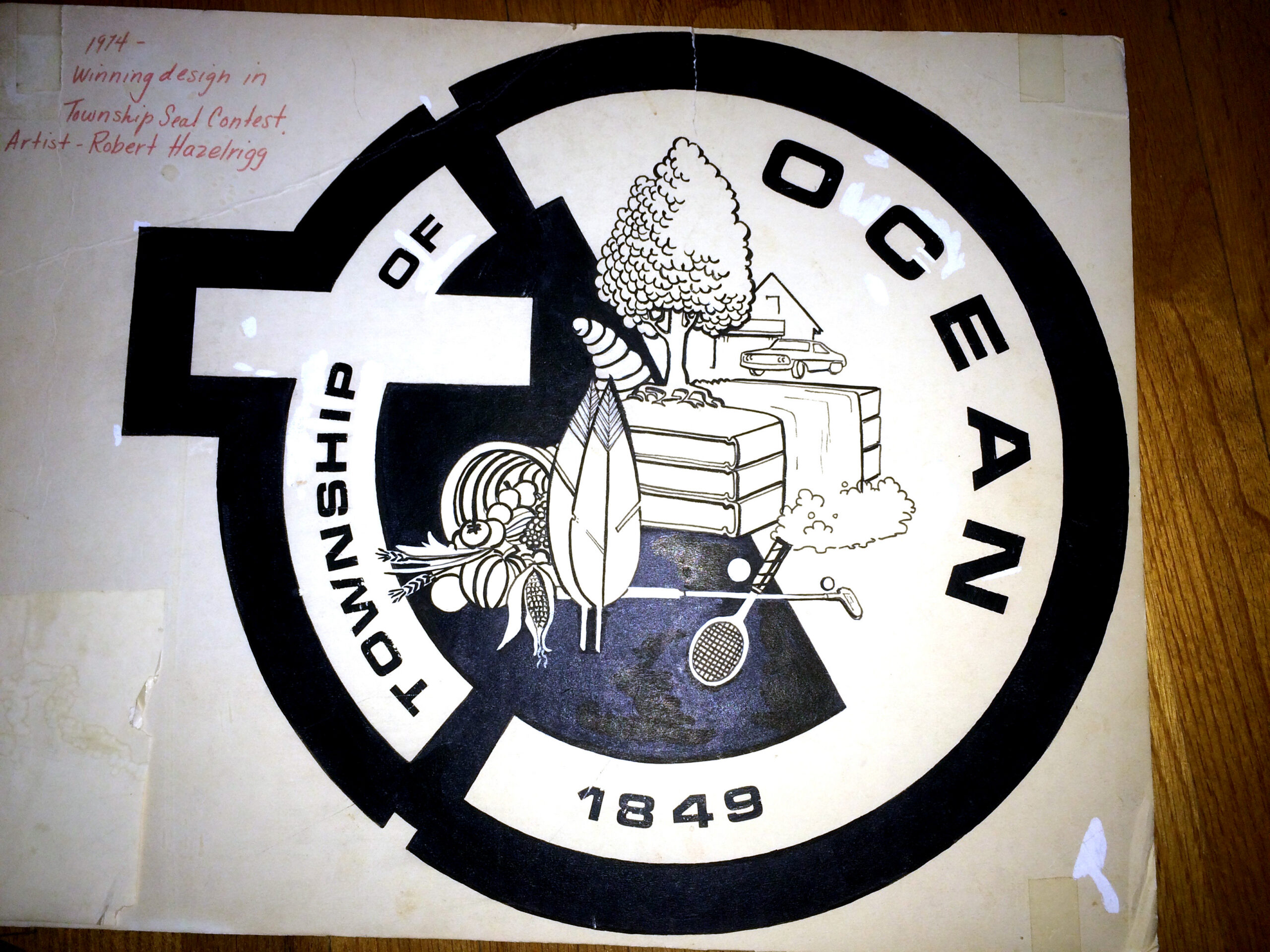 1974 Original 1974 Township of Ocean seal designed by Robert Hazelrigg, featuring a tree, house, books, corn, and sports equipment inside a circular emblem labeled “Township of Ocean 1849.”